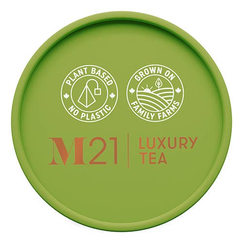 M21 Luxury Green Tea eco-friendly packaging with 'Plant Based No Plastic' and 'Grown on Family Farms' logos.