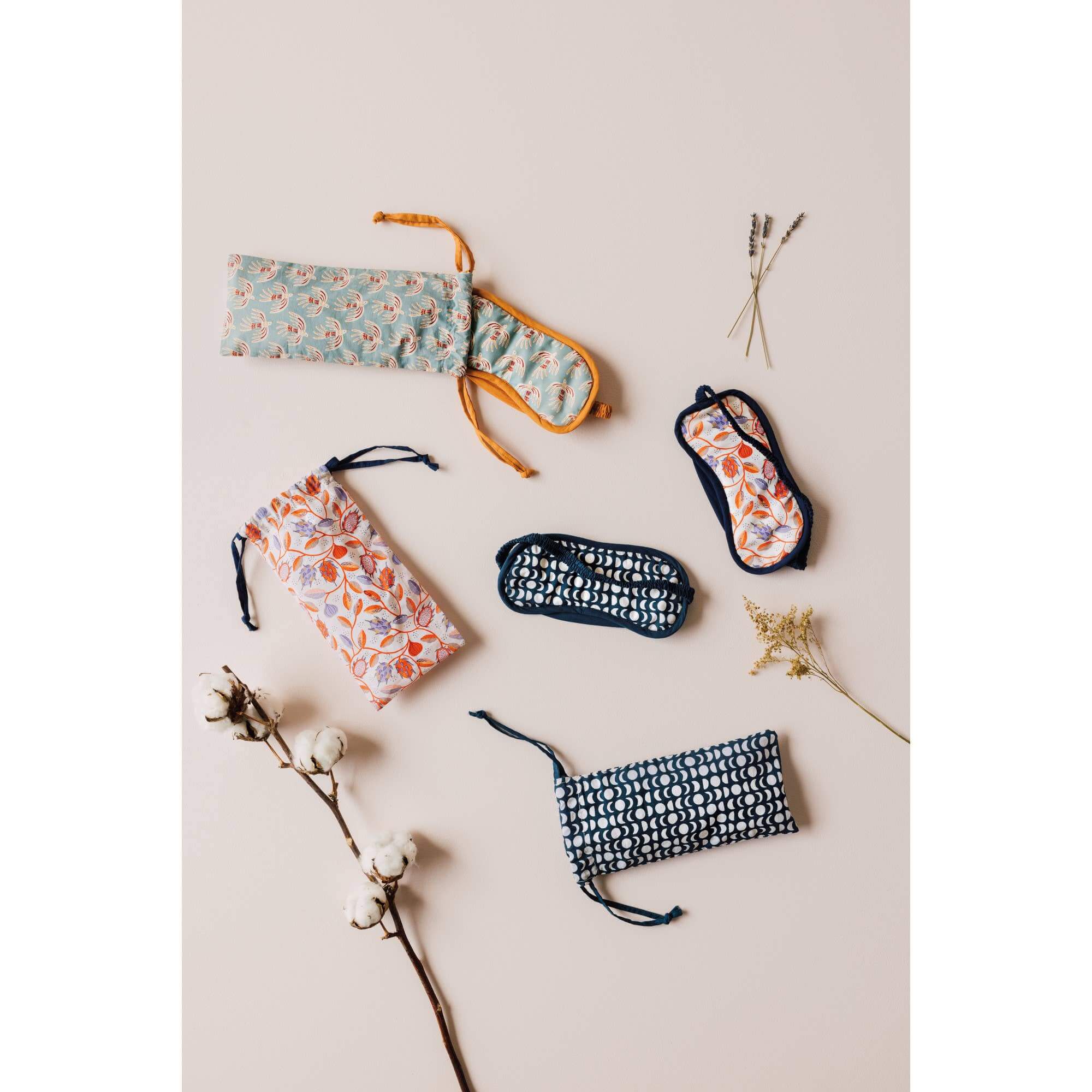 Ember Soft Cotton Sleep Masks in various patterns displayed elegantly on a soft background with decorative accents.