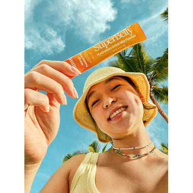 SuperBelly hydration drink powder in mango passionfruit flavor with fresh fruits and a refreshing glass of drink.