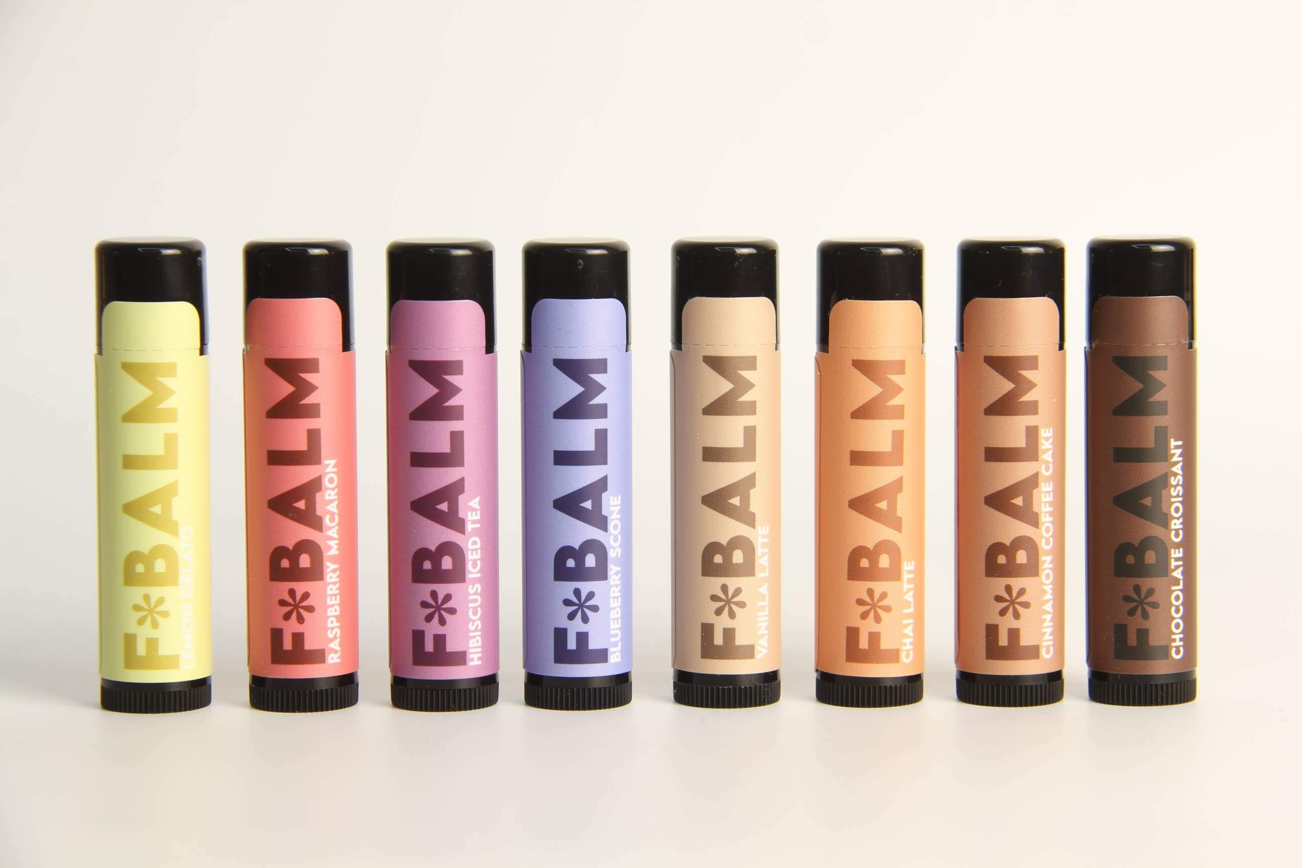 Collection of F*BALM lip balms in various flavors, made in Canada, showcasing vibrant packaging and natural ingredients.