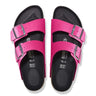 Birkenstock Women's Arizona Sandals in bright pink with rivet buckles and smooth black footbed, top view.