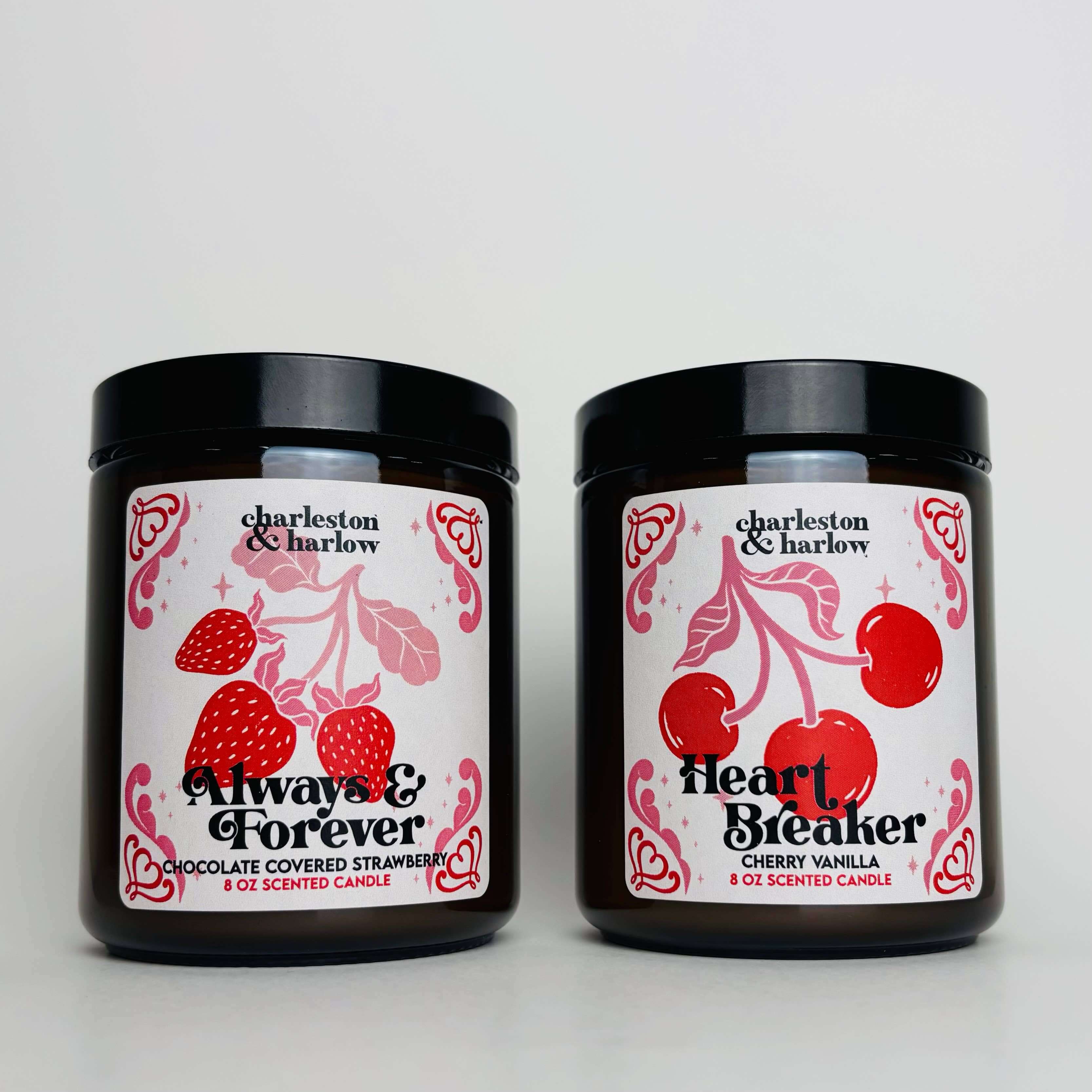 Always & Forever Chocolate Strawberry scented candle beside Heartbreaker Cherry Vanilla candle in elegant jars.