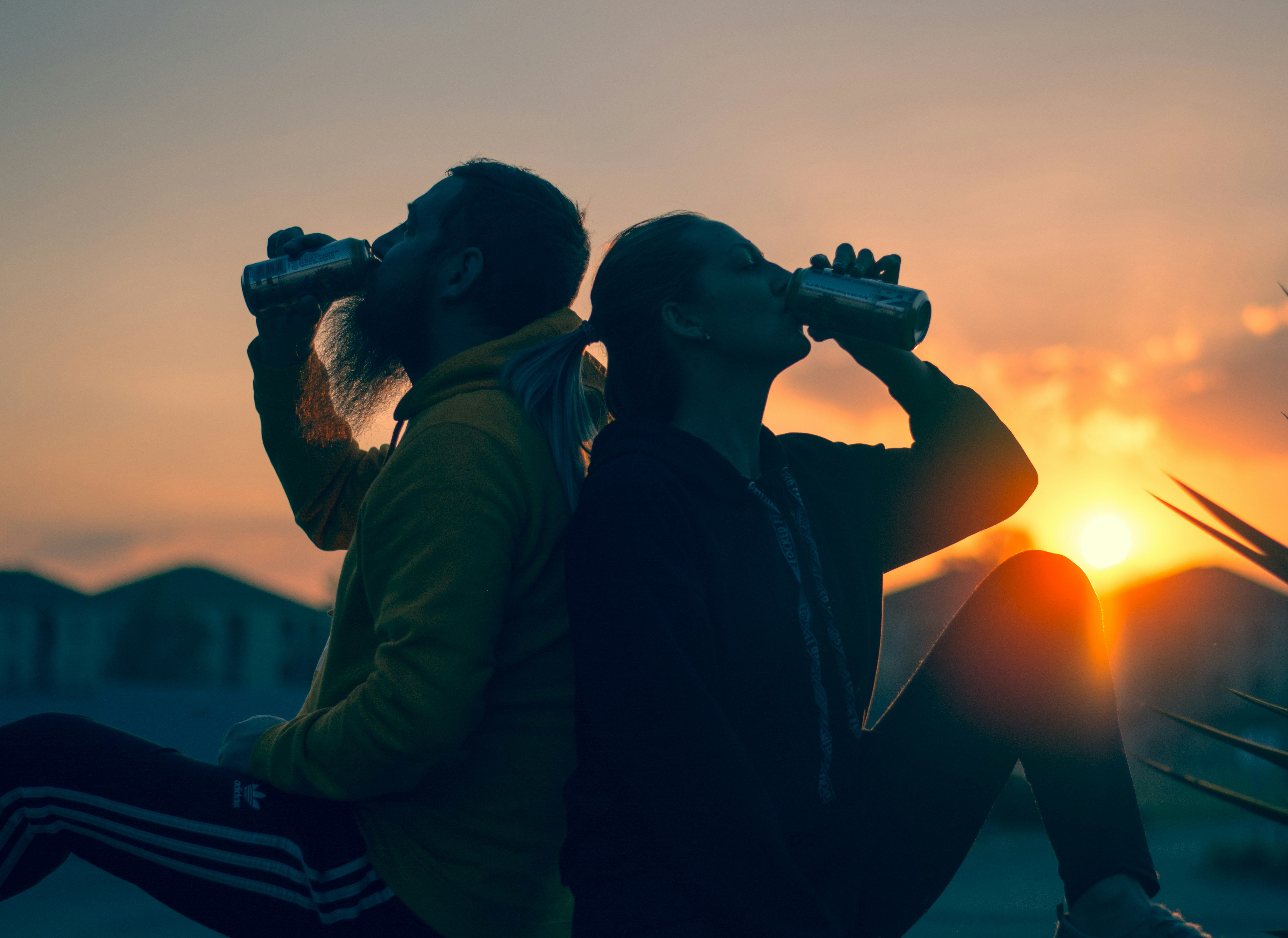 Wellness Products for Everyday Routines a couple hydrating at sunset