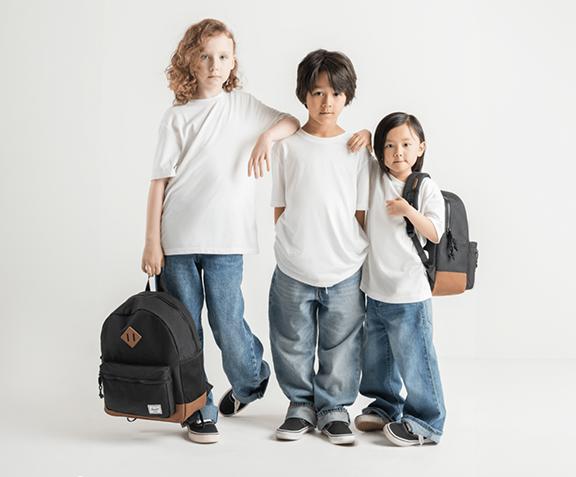 Vans Herschel kids holding backpacks and Vans Old Skool Running Shoes