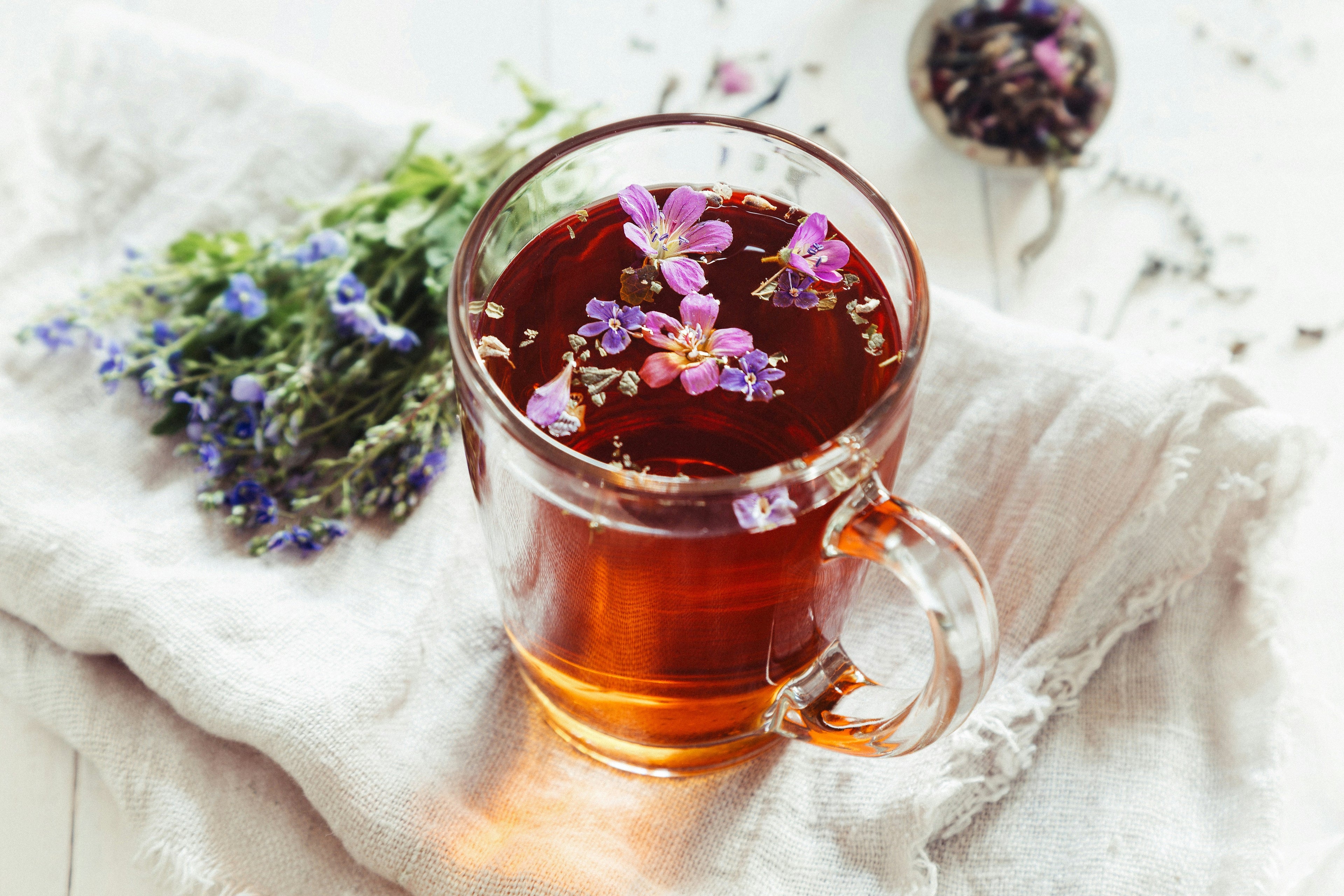 Organic tea steeping in a glass teacup