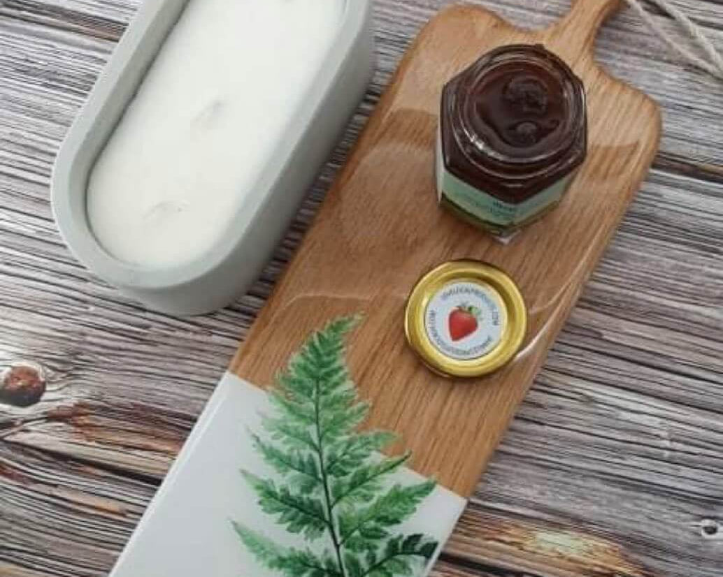 candle, cutting board and jam on a wood table