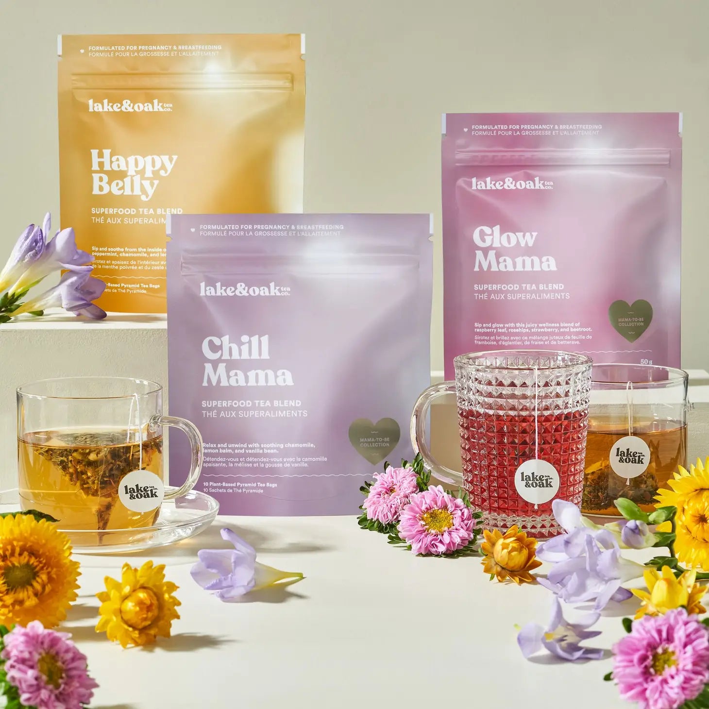 Lake & Oak tea packages with cups of tea and flowers on a light background