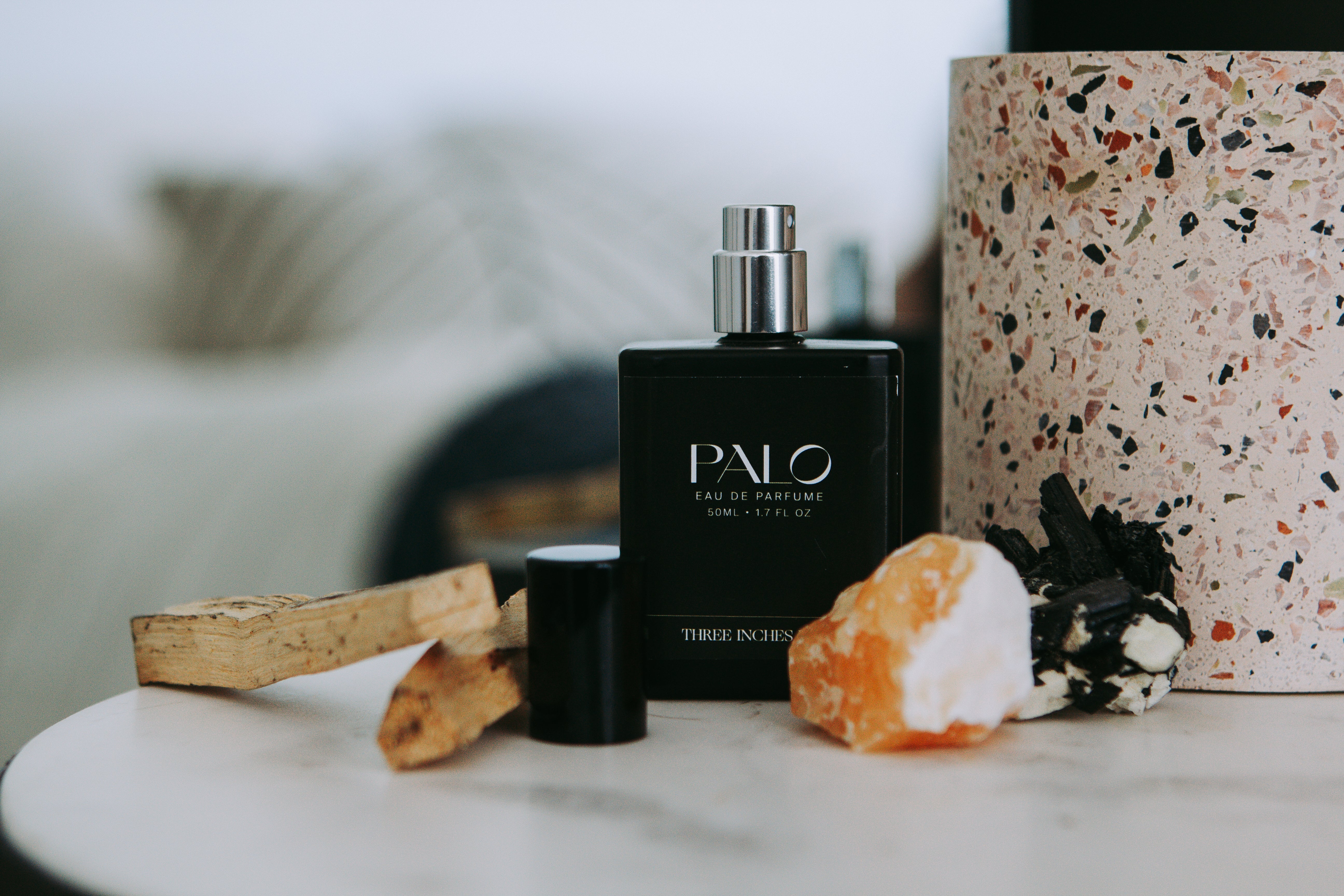 Palo perfume bottle on a table with decorative items