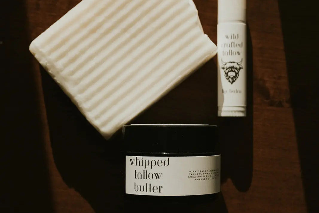 Three skincare products on a wooden surface: a jar, a bottle, and a soap bar.