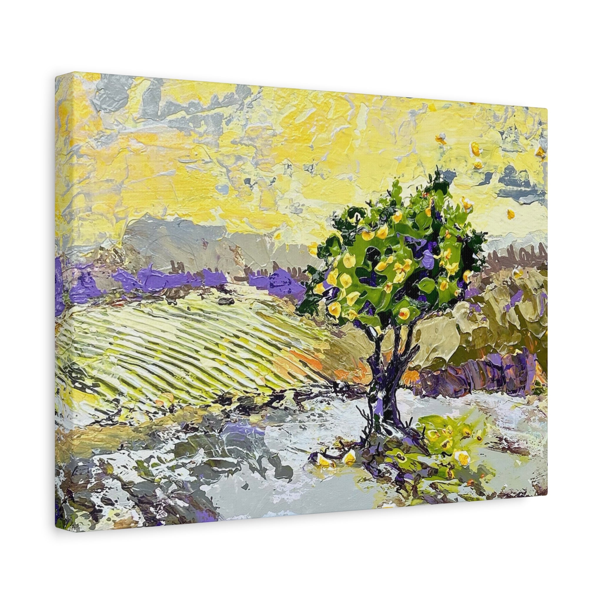 An impressionistic canvas wall art print depicting a landscape with a green tree, lavender fields, and a bright yellow sky, shown at an angle on a white background.