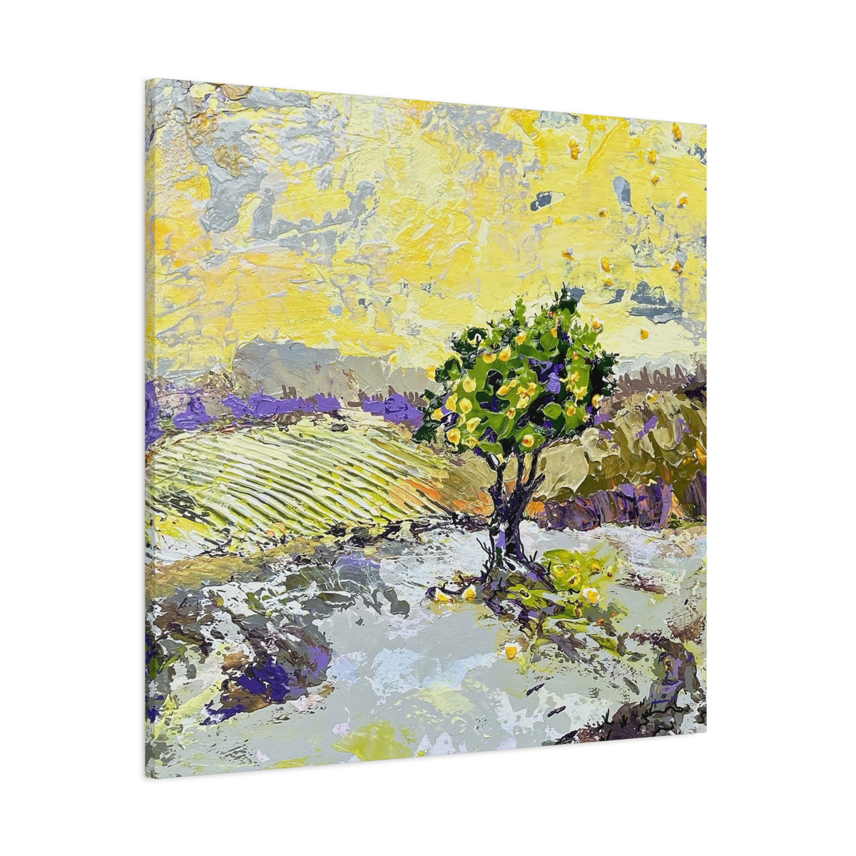 Square canvas wall art featuring an impressionistic landscape painting with a green tree in a field, rendered in yellow, gray, purple, and green tones, shown at a slight angle on a white background.
