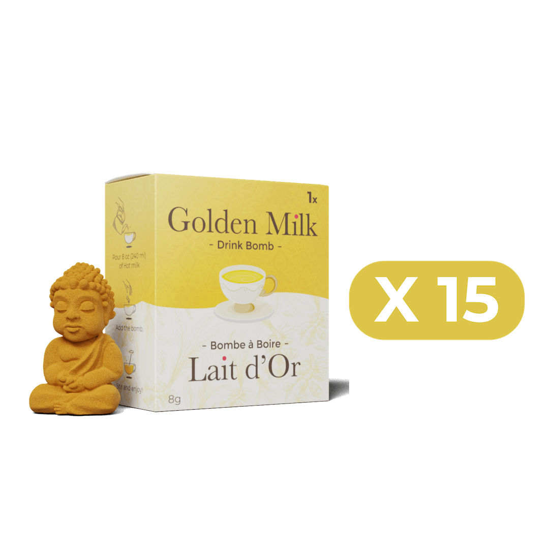 Box of Golden Milk drink bombs with a small Buddha statue on a black background