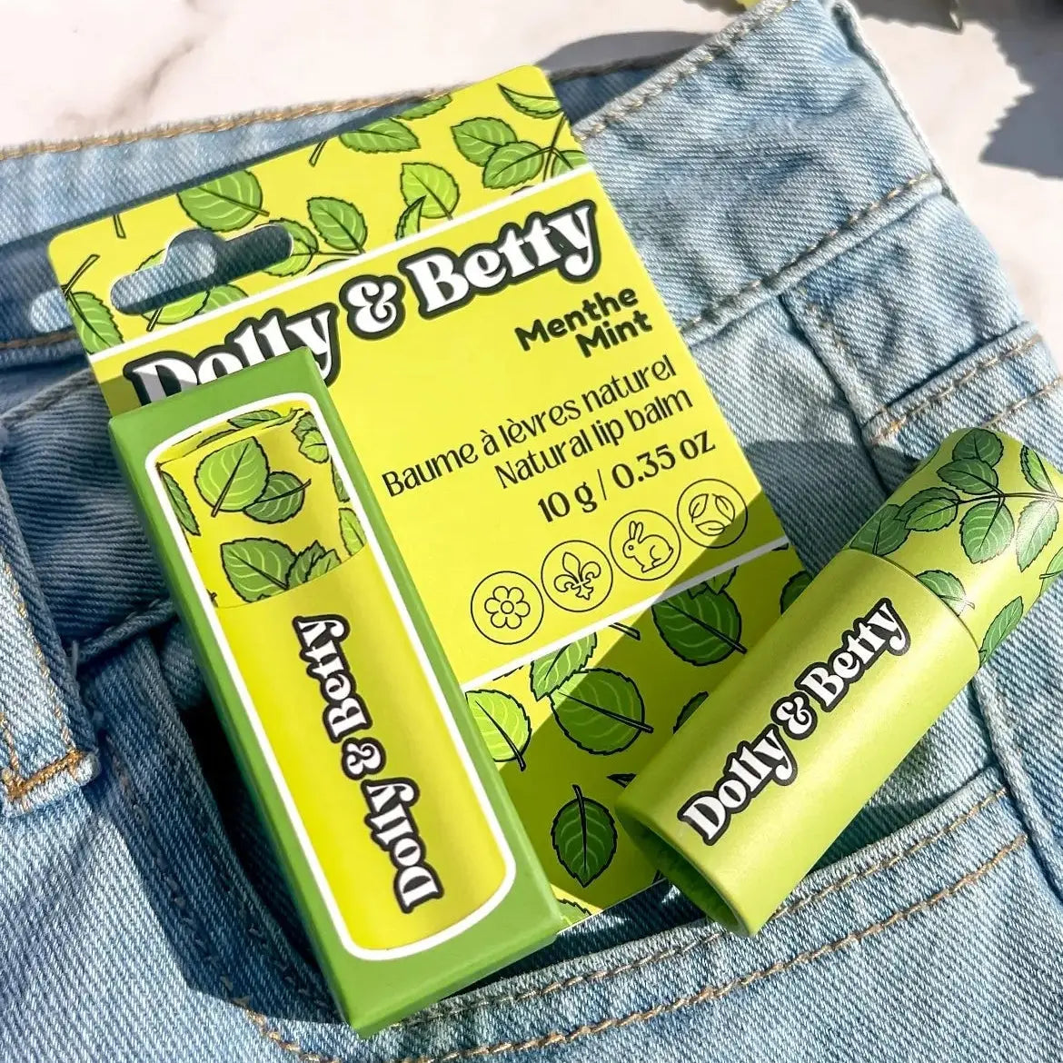 Dolly & Betty menthe mint lip balm with packaging on denim fabric