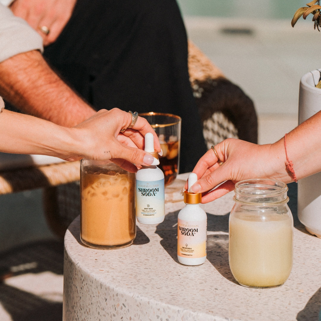 Ananda Elixirs Shroom Soda® – Sugar-Free Soda Mix – Lifestyle product shot with mocktail glass