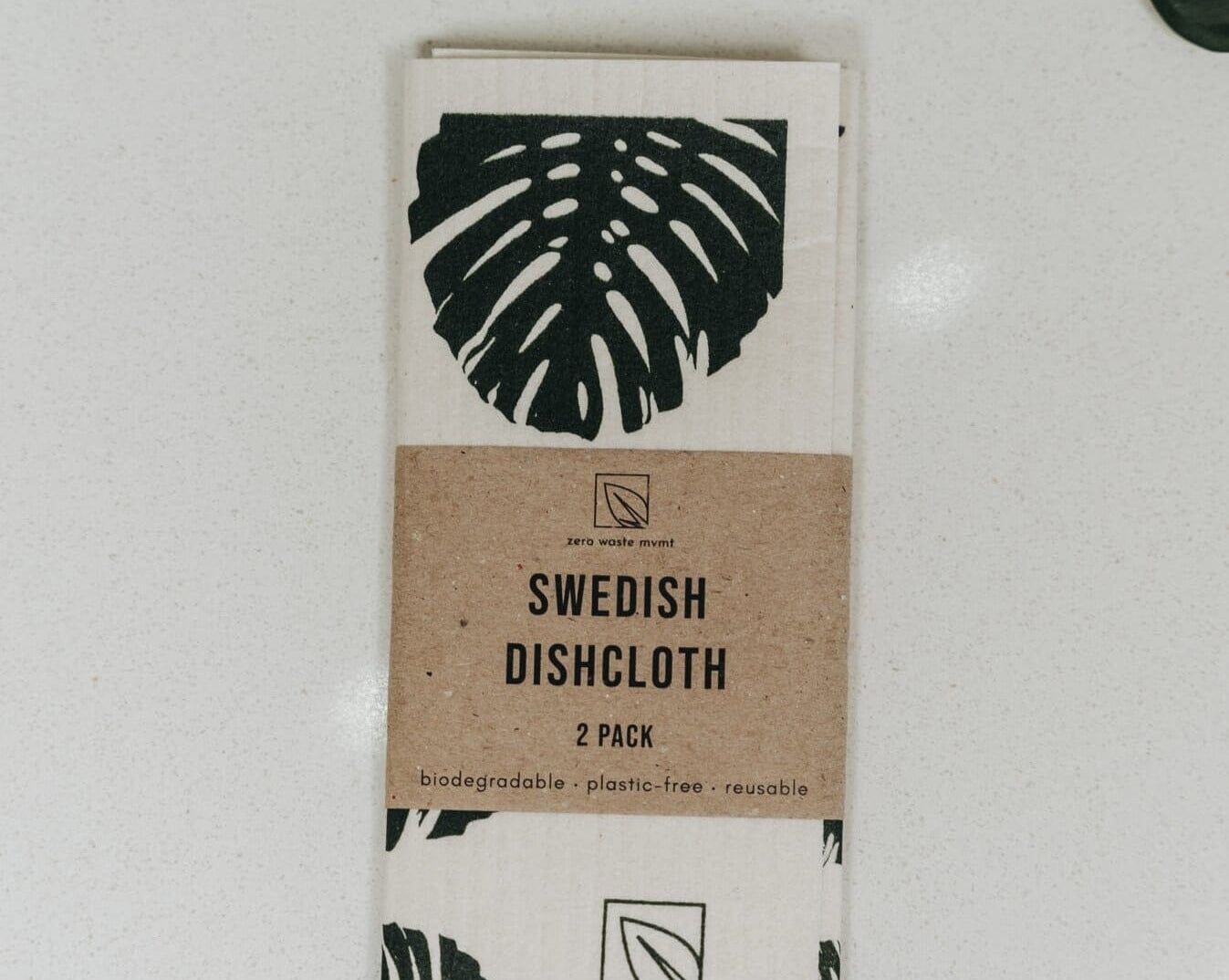 Two Swedish dishcloths with leaf patterns on a white background