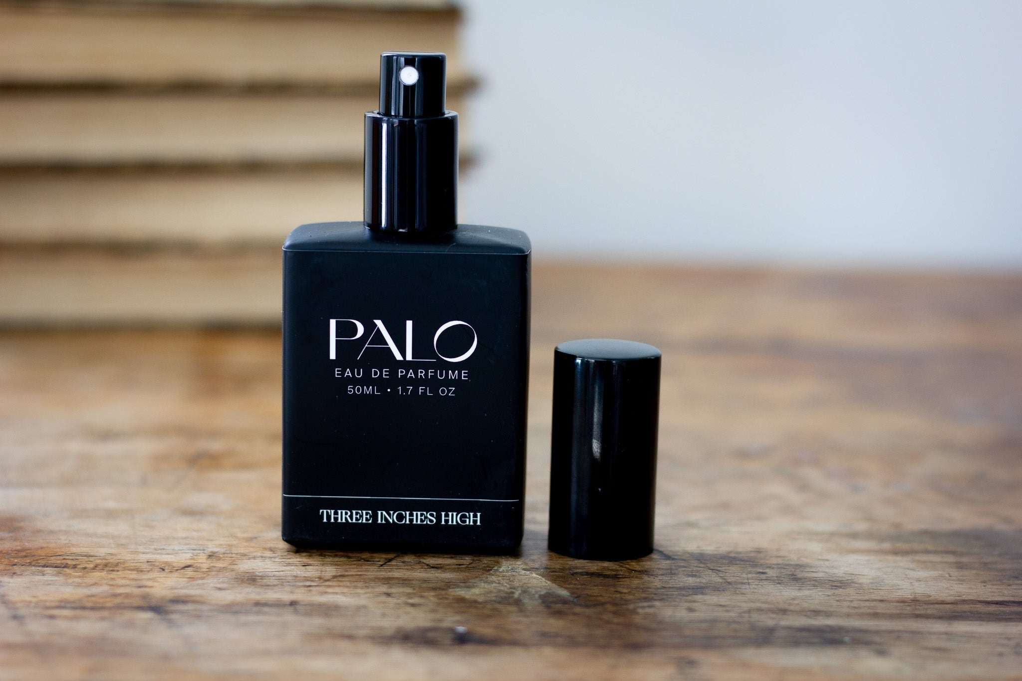 Black Palo perfume bottle on a wooden surface