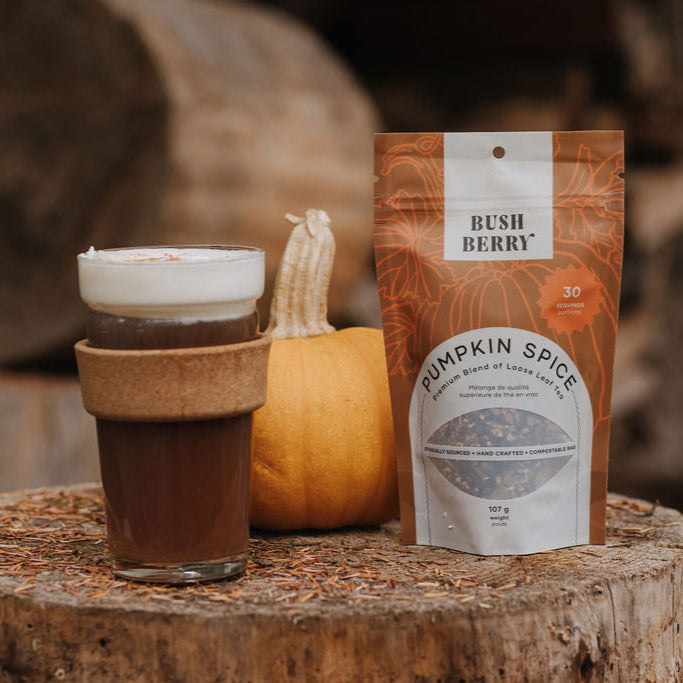 Organic Pumpkin Spice Tea and packaging on a wooden surface with a blurred background