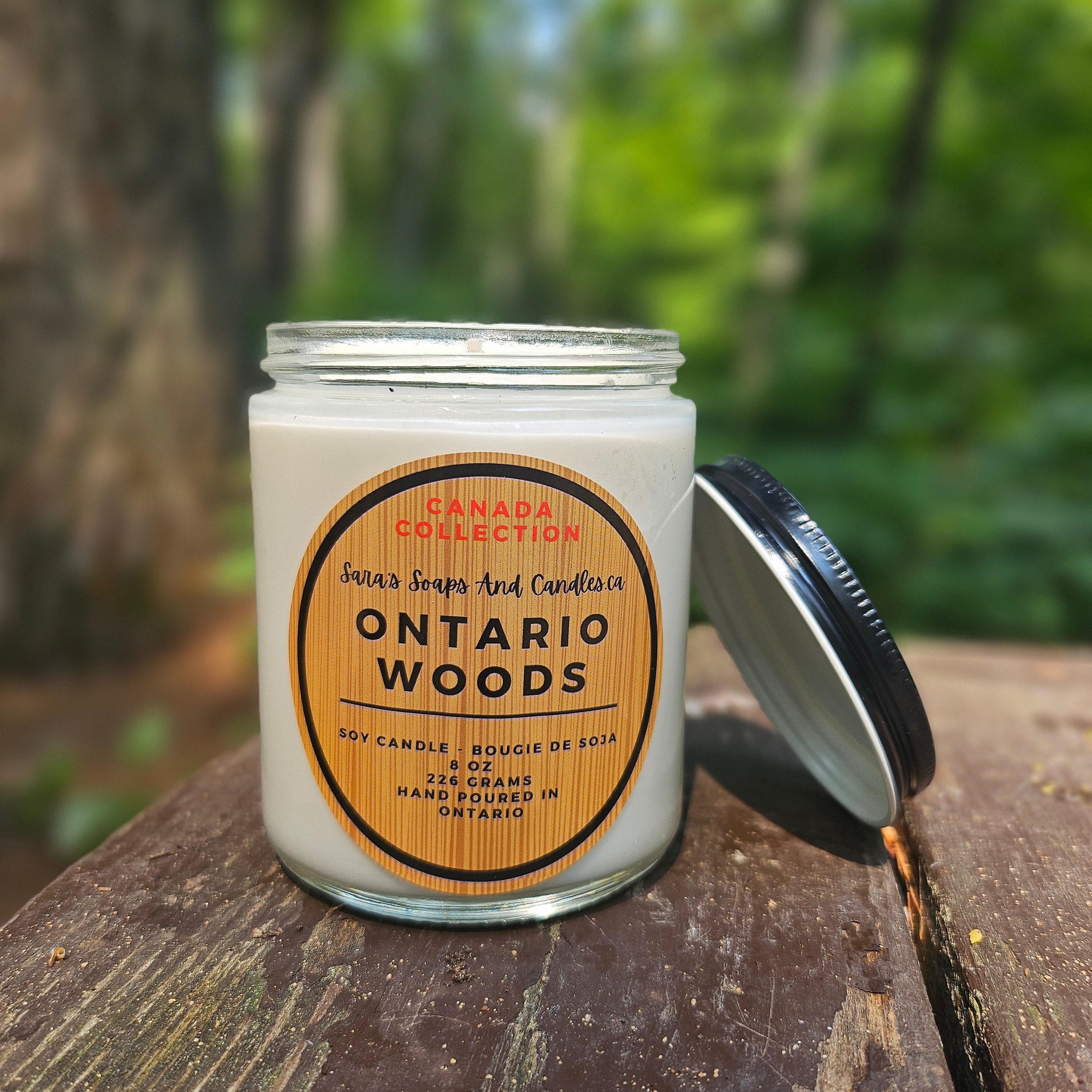 Candle jar labeled 'Ontario Woods' on a wooden surface with a natural background