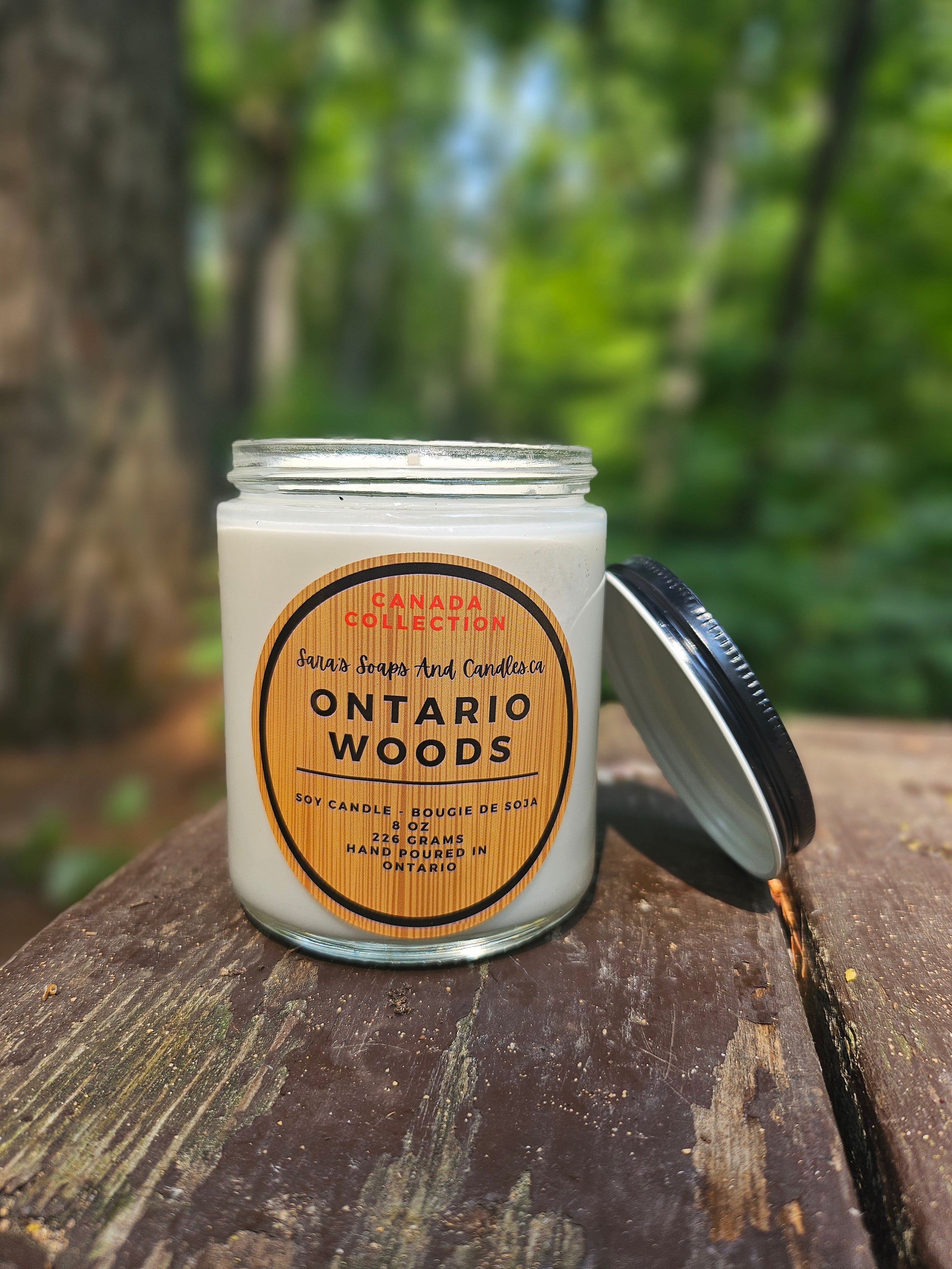 Candle jar labeled 'Ontario Woods' on a wooden surface with a natural background