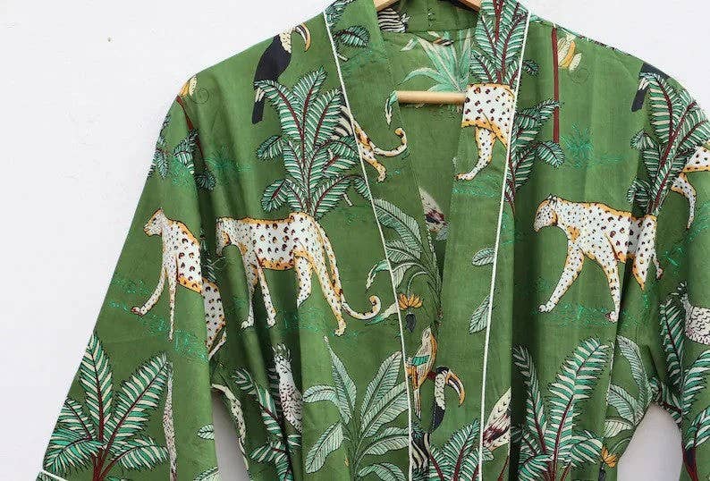 Women's boho kimono robe featuring animal print and greenery, crafted from organic cotton fabric.