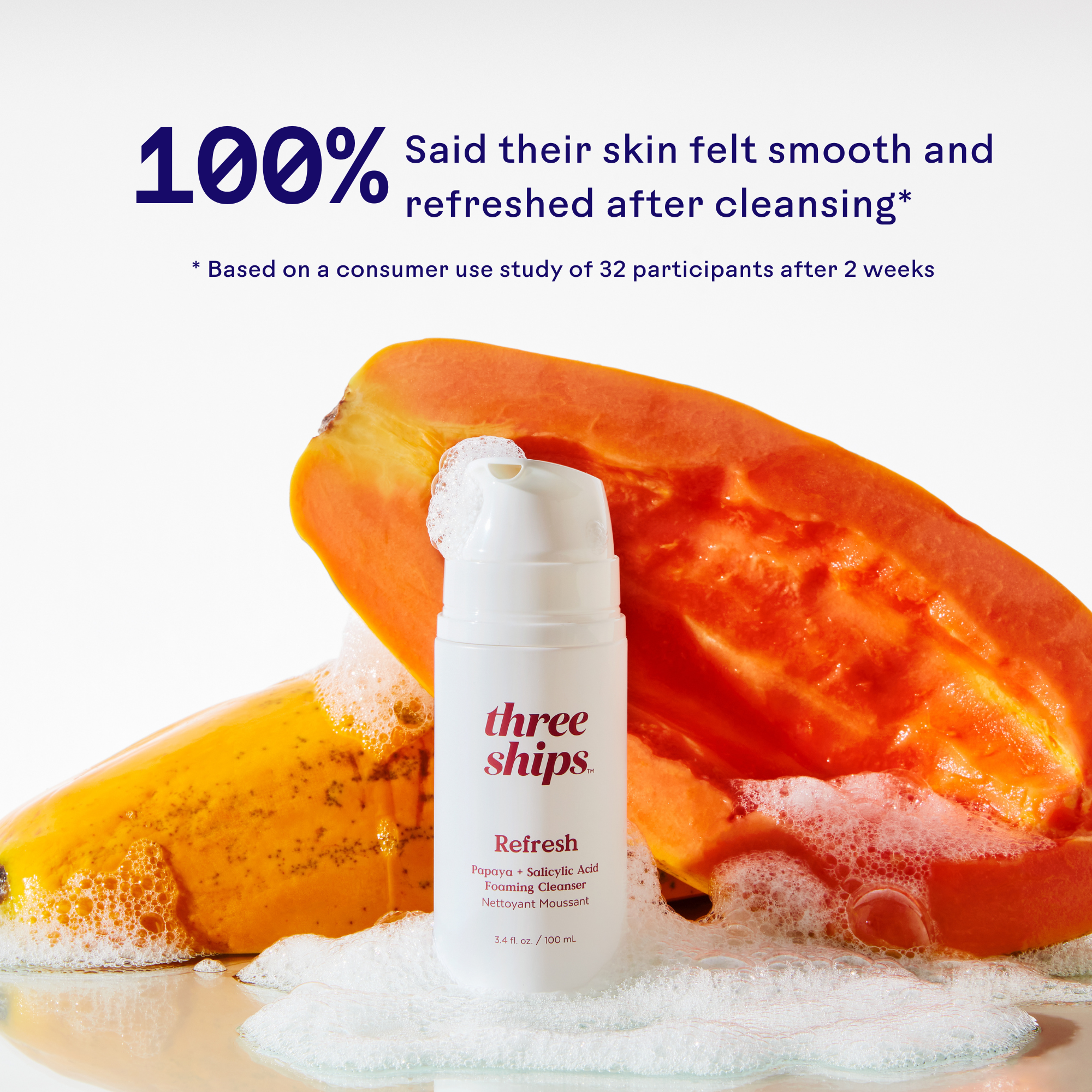 Bottle of Refresh Papaya + Salicylic Acid Cleanser with papaya slices, highlighting skin smoothness and freshness.