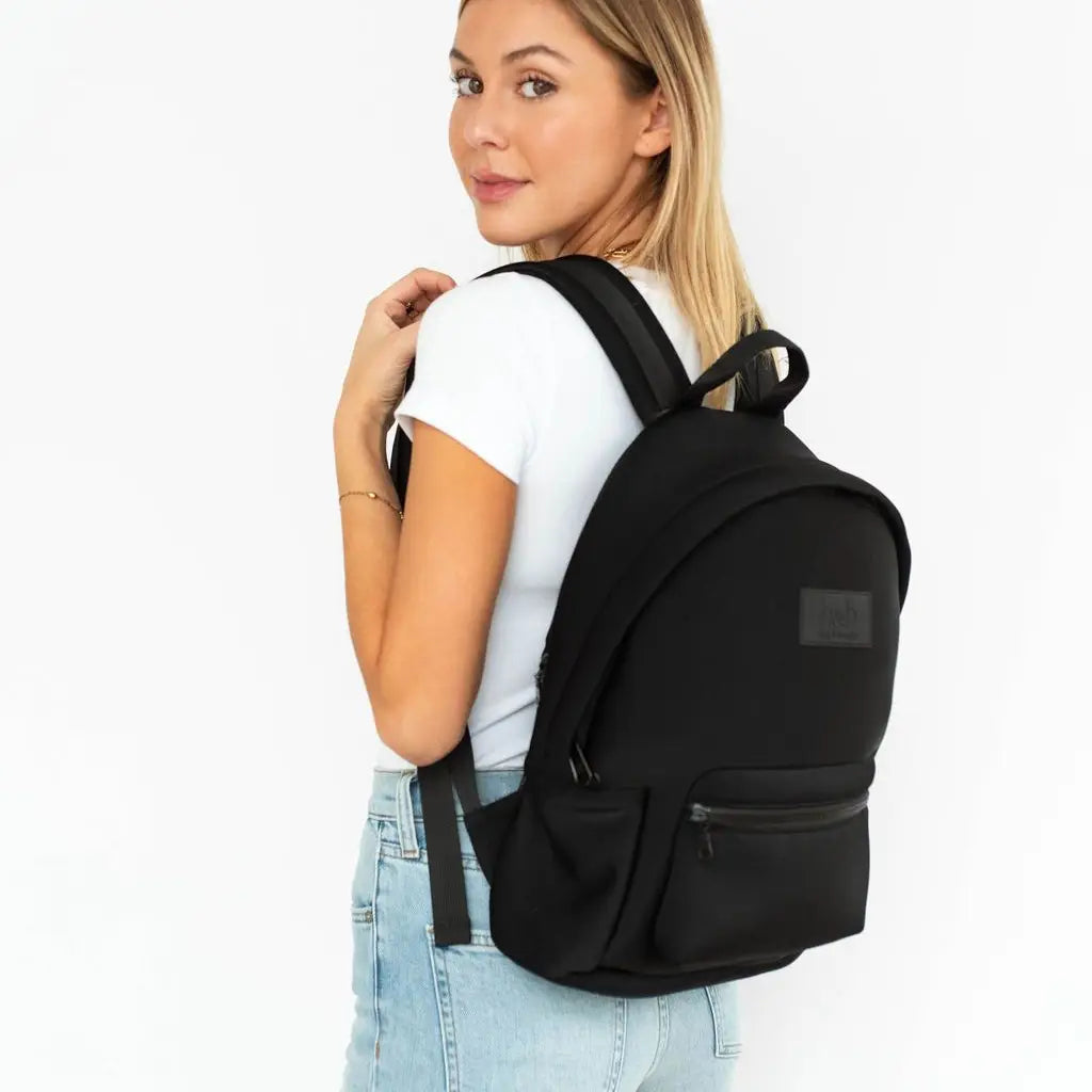 Woman wearing a black backpack on a white background