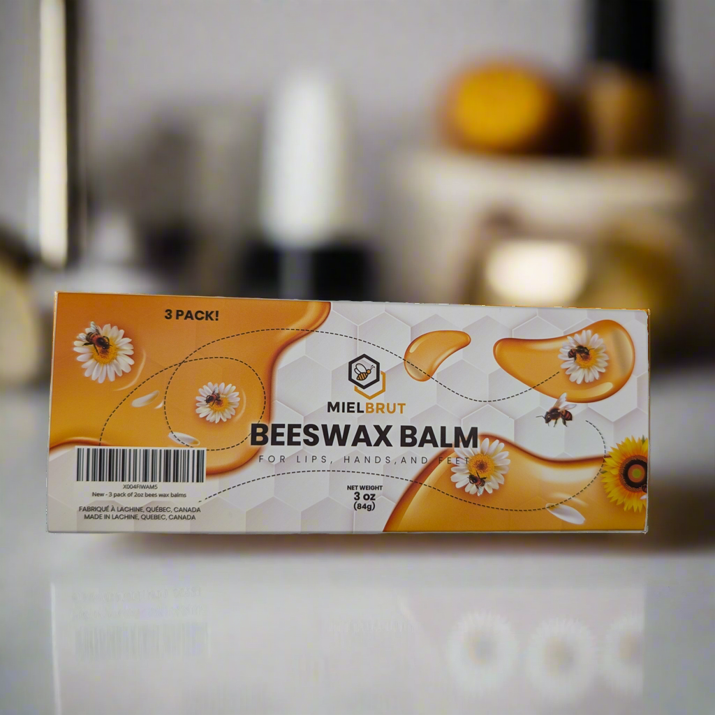 Box of Miel Brut beeswax balm on a marble surface with a blurred background