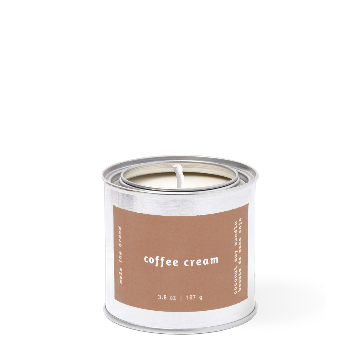 Candle in a metal tin labeled 'coffee cream' on a white background