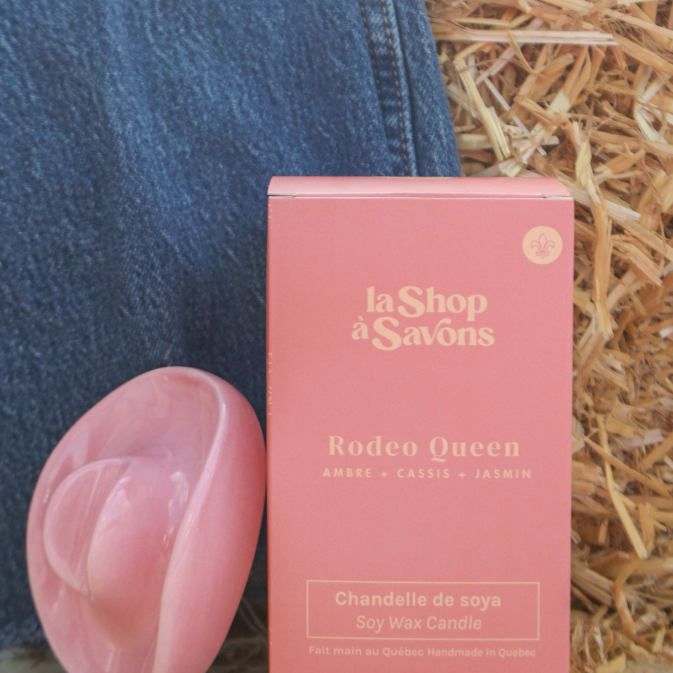 Pink soap bar and packaging with 'la Shop a Savons' branding on a textured surface.