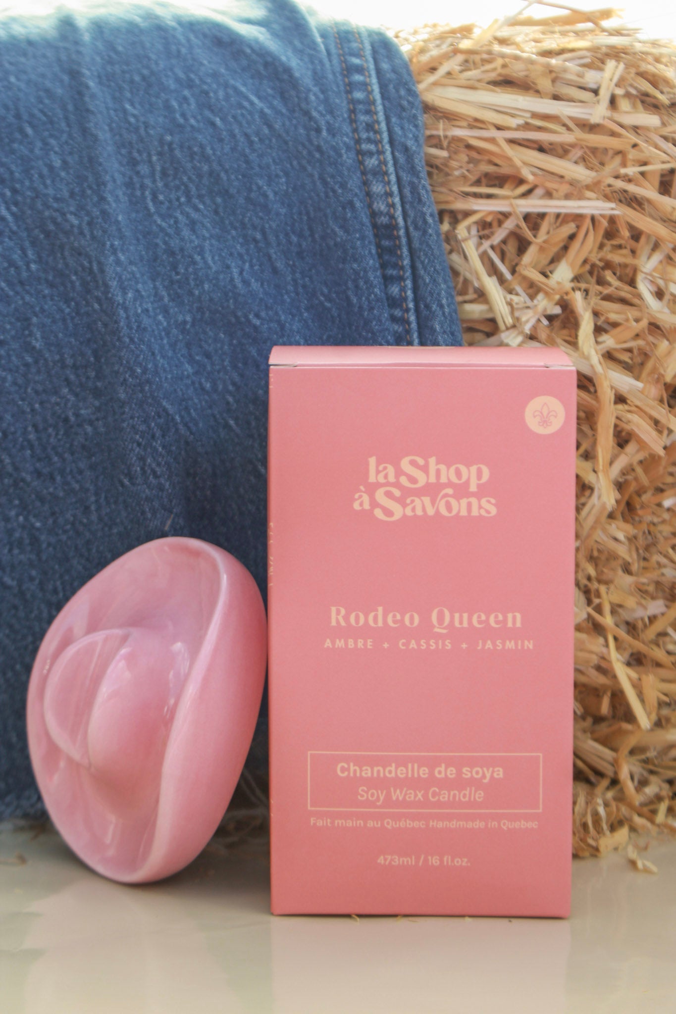 Pink soap bar and packaging with 'la Shop a Savons' branding on a textured surface.