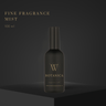 Black fragrance mist bottle with 'W Botanica' branding on a dark background