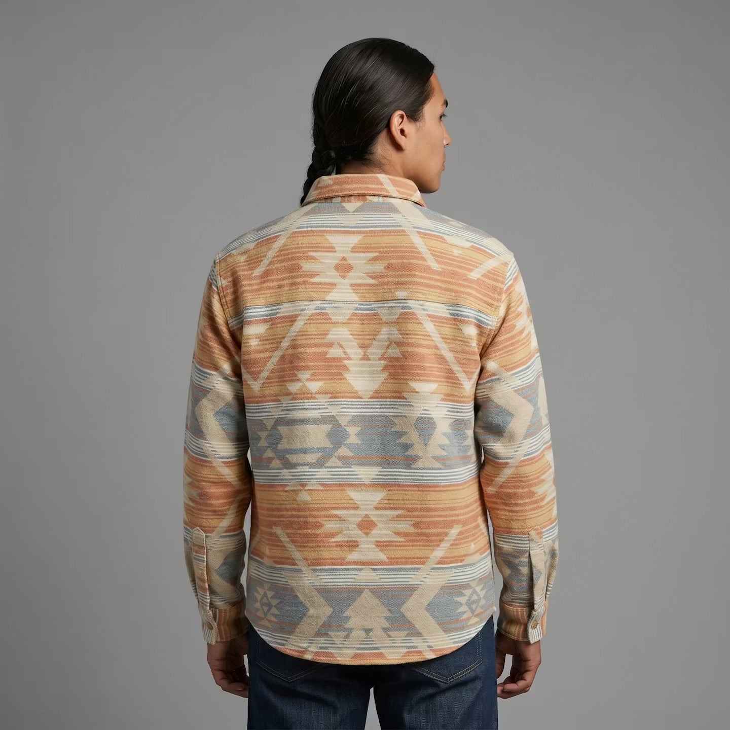 Person wearing a patterned shirt with a gray background