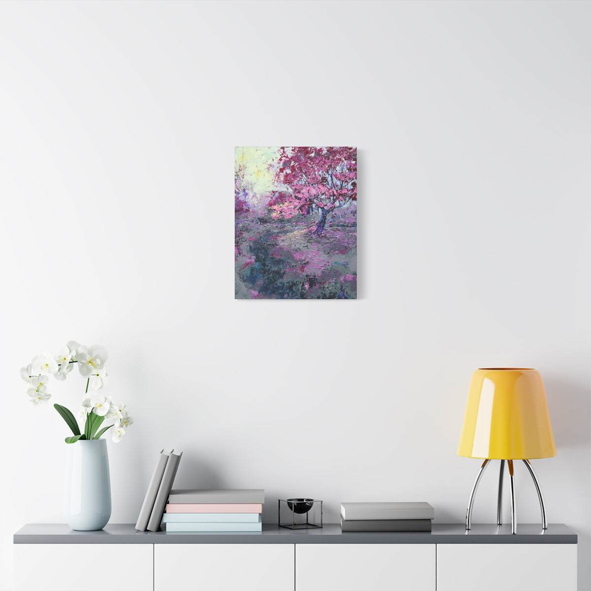Nancy Overbury canvas print – Heather of the Rocks – pink flowering tree hanging on a wall over a desk and yellow lamp