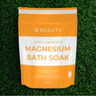 Orange and white package of OC Beauty Neroli + Grapefruit Magnesium Bath Soak