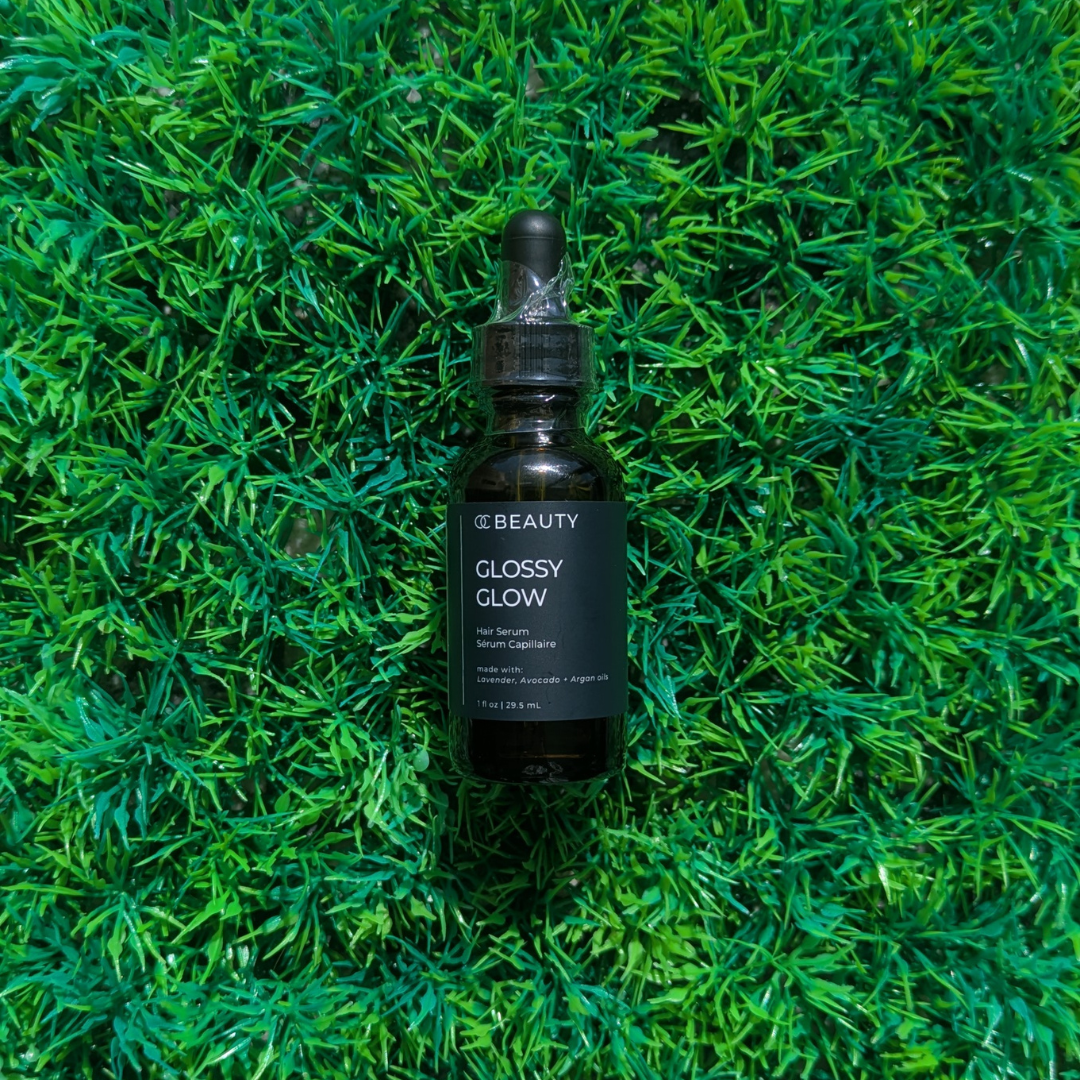 OC Beauty - Glossy Glow Hair Oil Black bottle on green grass