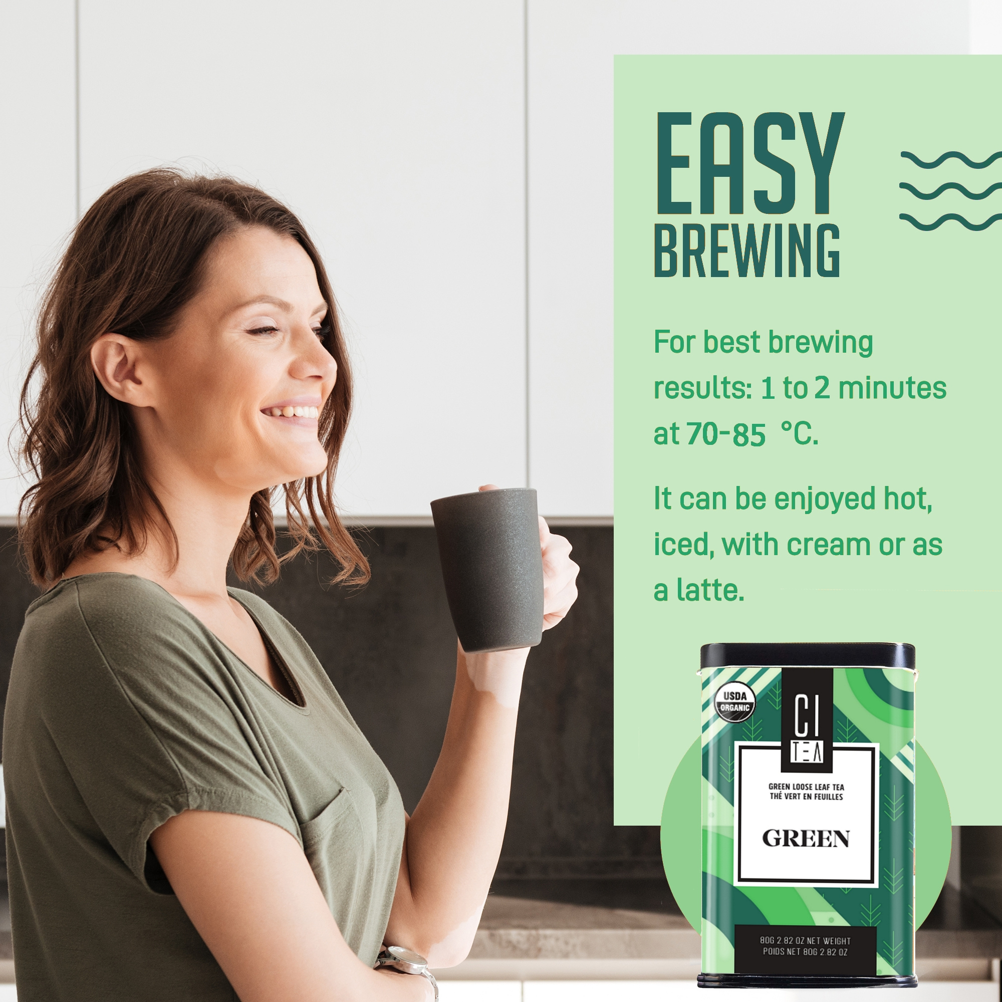 Woman holding a mug with green tea packaging and brewing instructions on a kitchen counter.