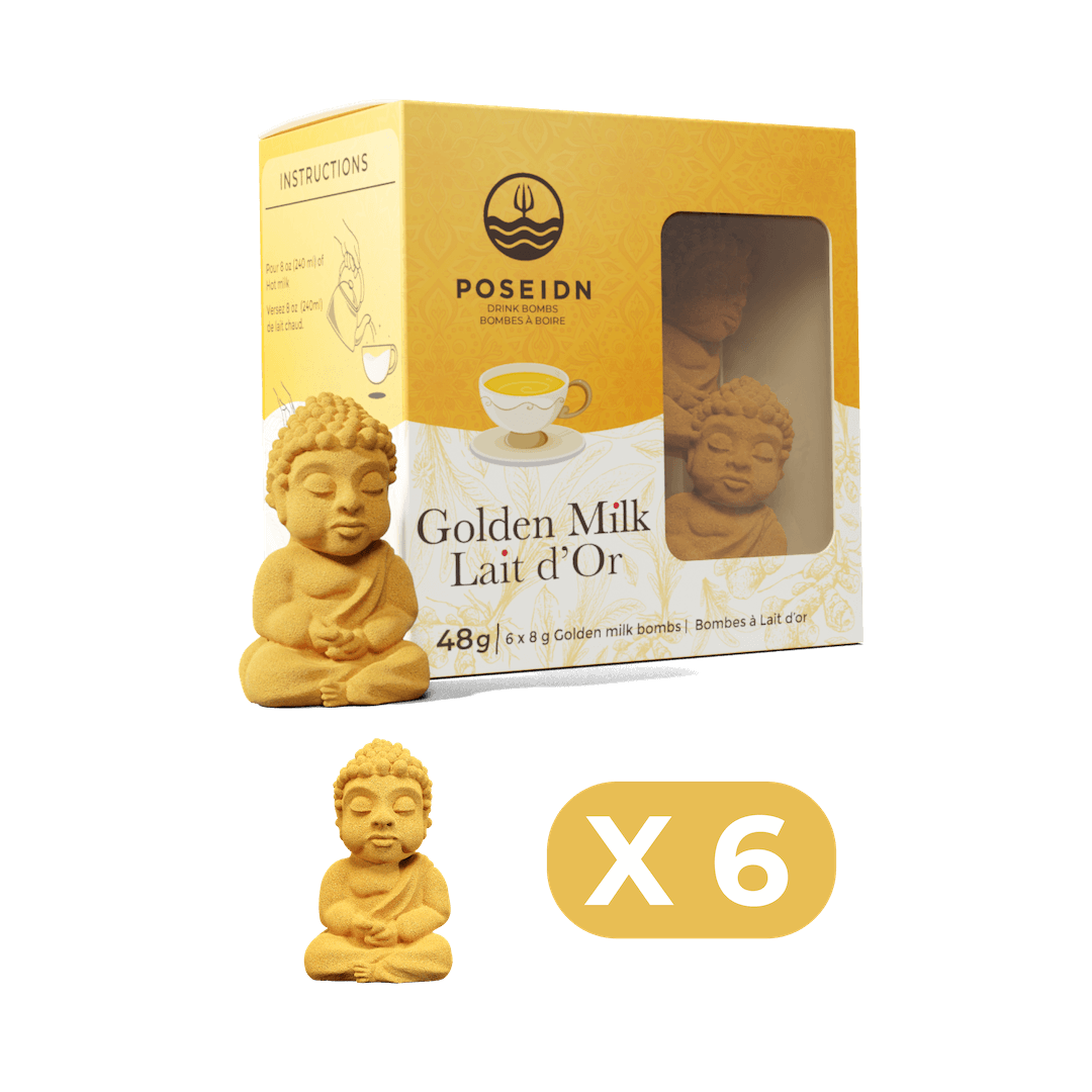 Box of Poseidn Golden Milk Lait d'Or Posiedn Golden Milk bomb flavo with two golden milk bomb sculptures on a black background