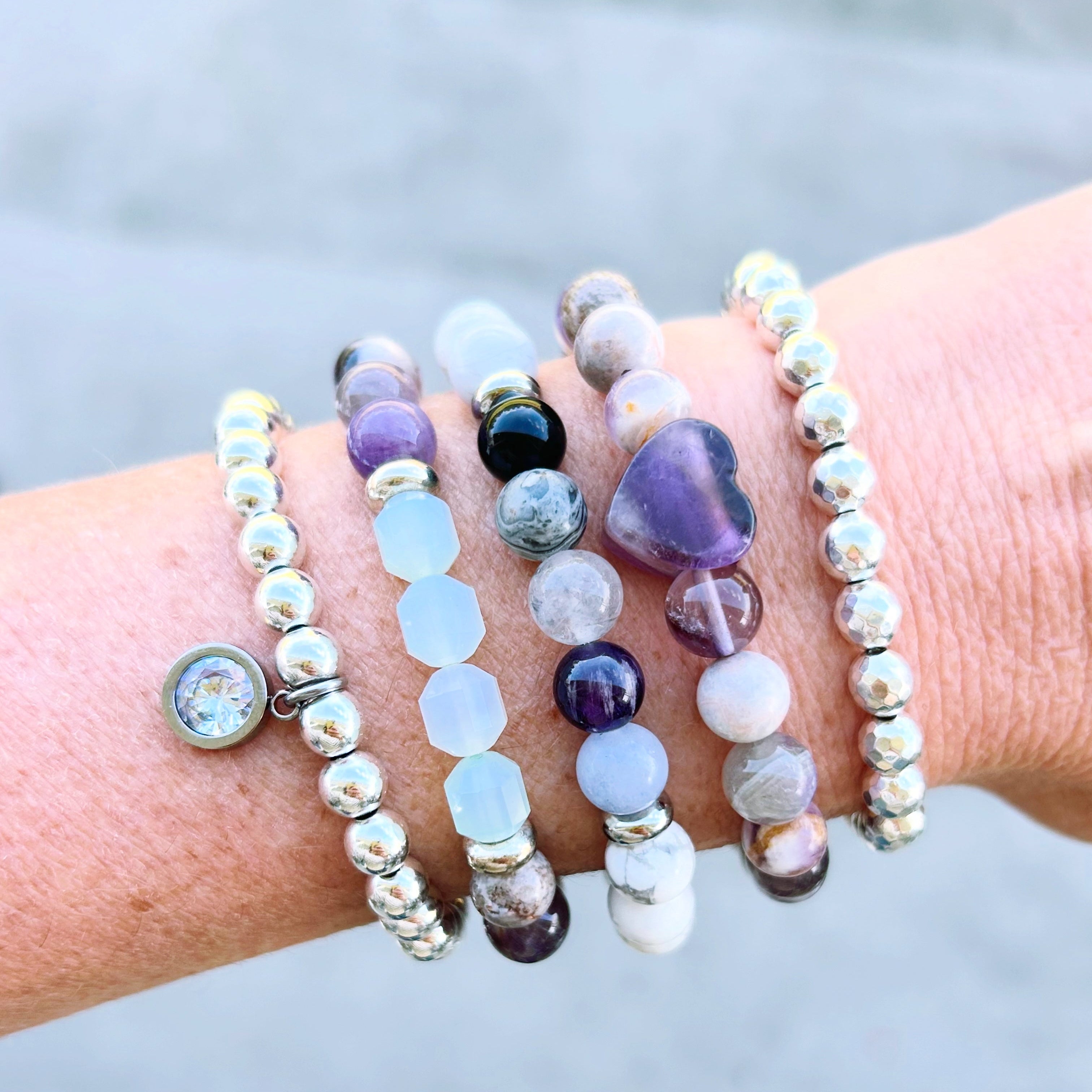 Healing Stack, thoughtfully designed to combine the natural beauty of powerful gemstones: Amethyst, Onyx, Jade, Jasper, Howlite, Hematite and Quartz.