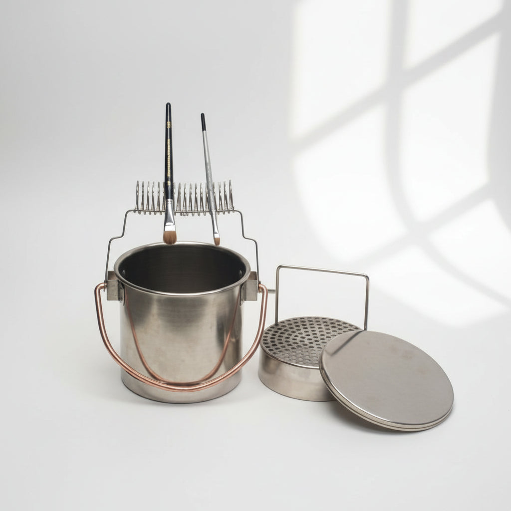 Metal paintbrush holder pot with lid and wire rack holding paint brushes on a white background