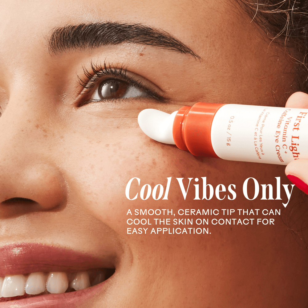 Applying First Light Vitamin C + Caffeine Eye Cream with a cool ceramic tip for brightening and de-puffing the under-eye area.