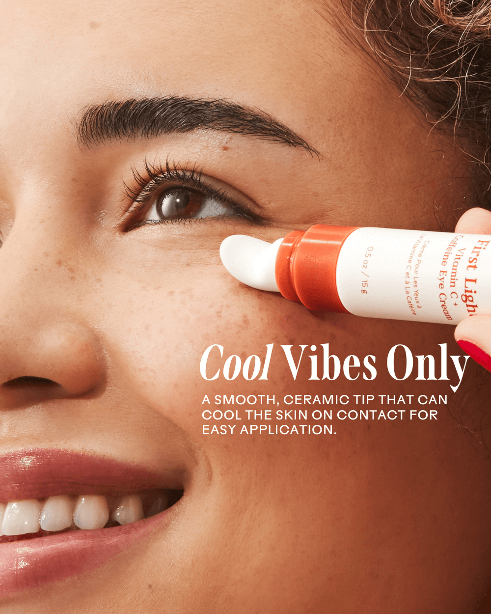 Applying First Light Vitamin C + Caffeine Eye Cream with a cool ceramic tip for brightening and de-puffing the under-eye area.