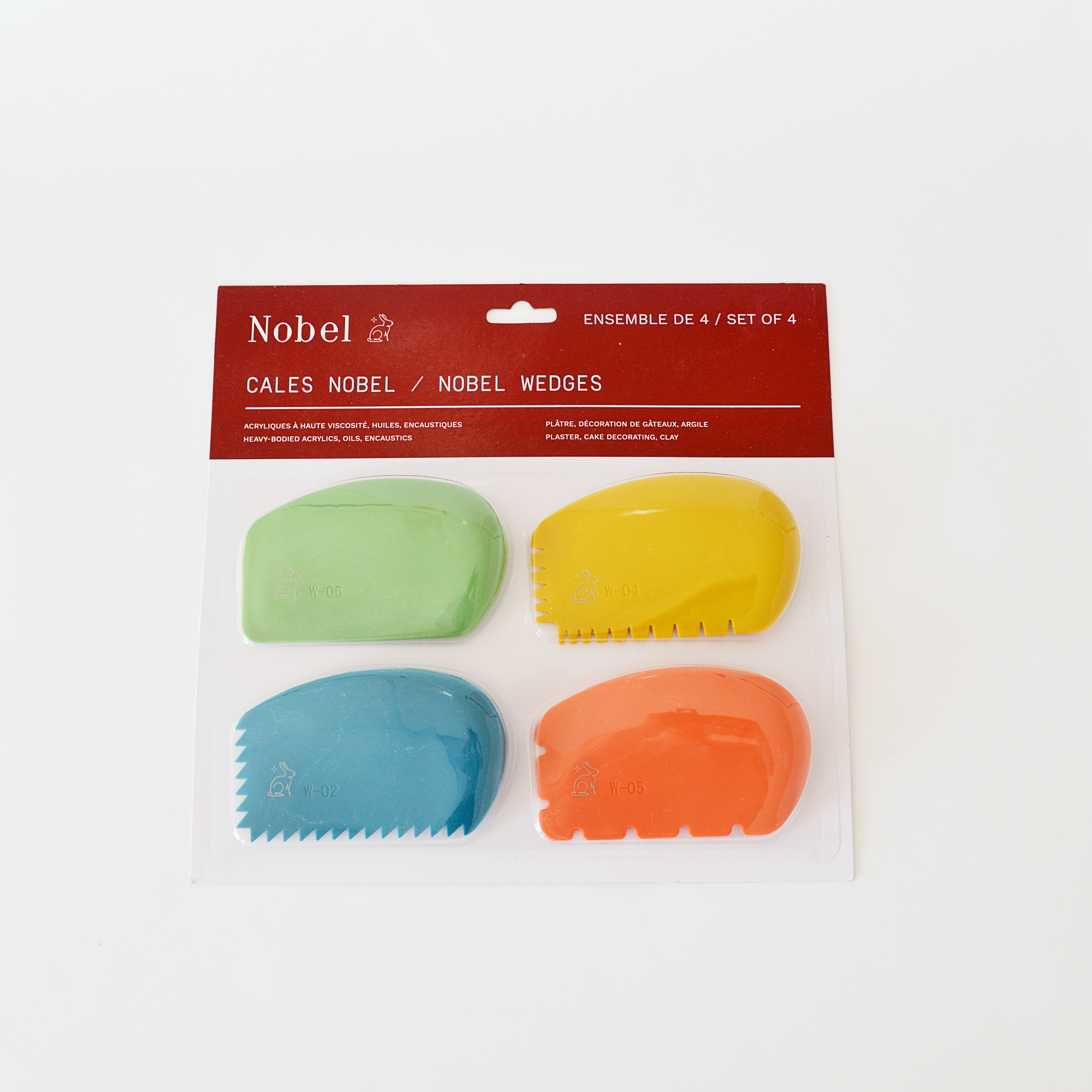 Set of four colorful paint wedges or cake decorating wedges in packaging with Nobel branding.