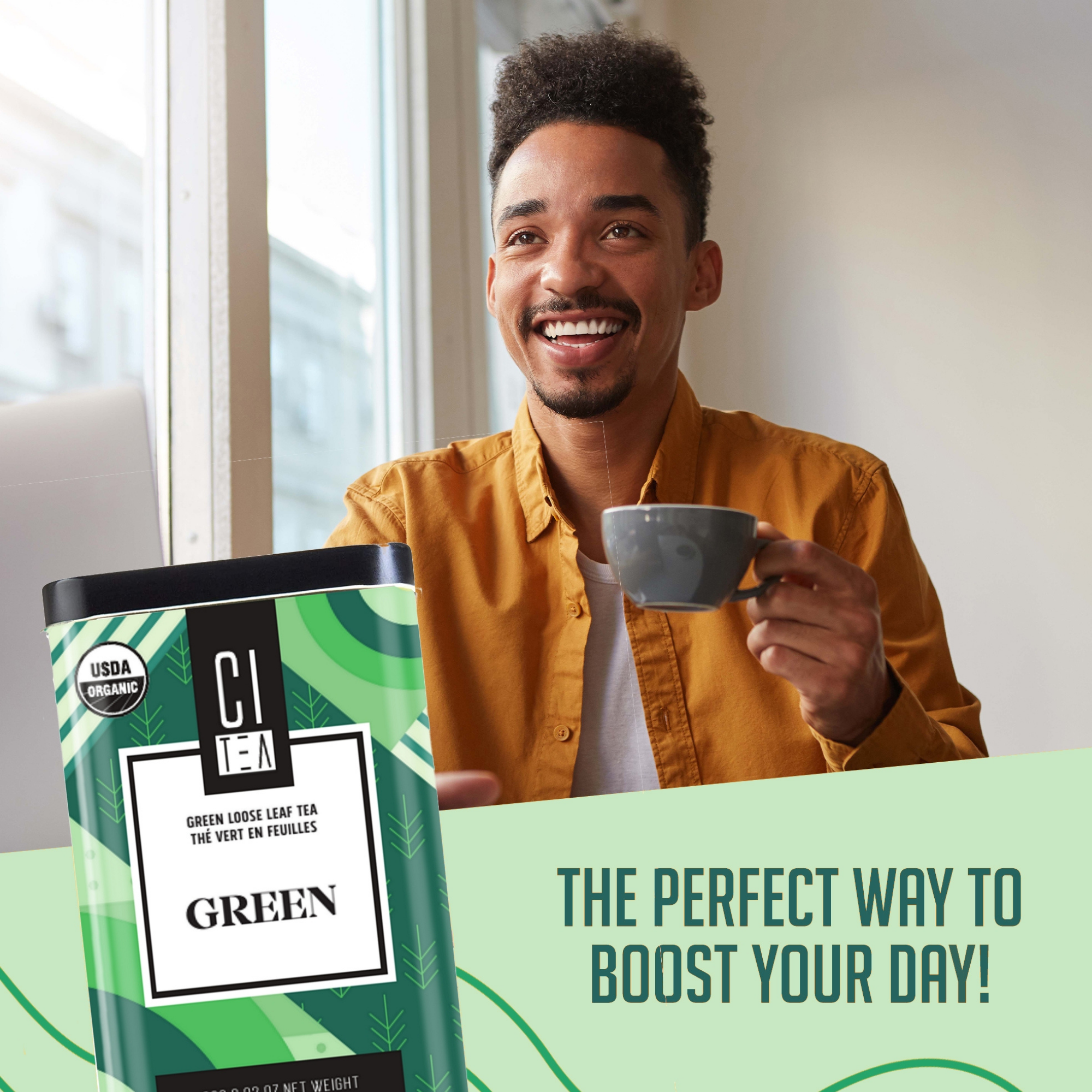 Man holding a mug with a green tea package and text about boosting your day.