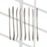 Set of metal sculpture rasps tools with textured handles on a white background