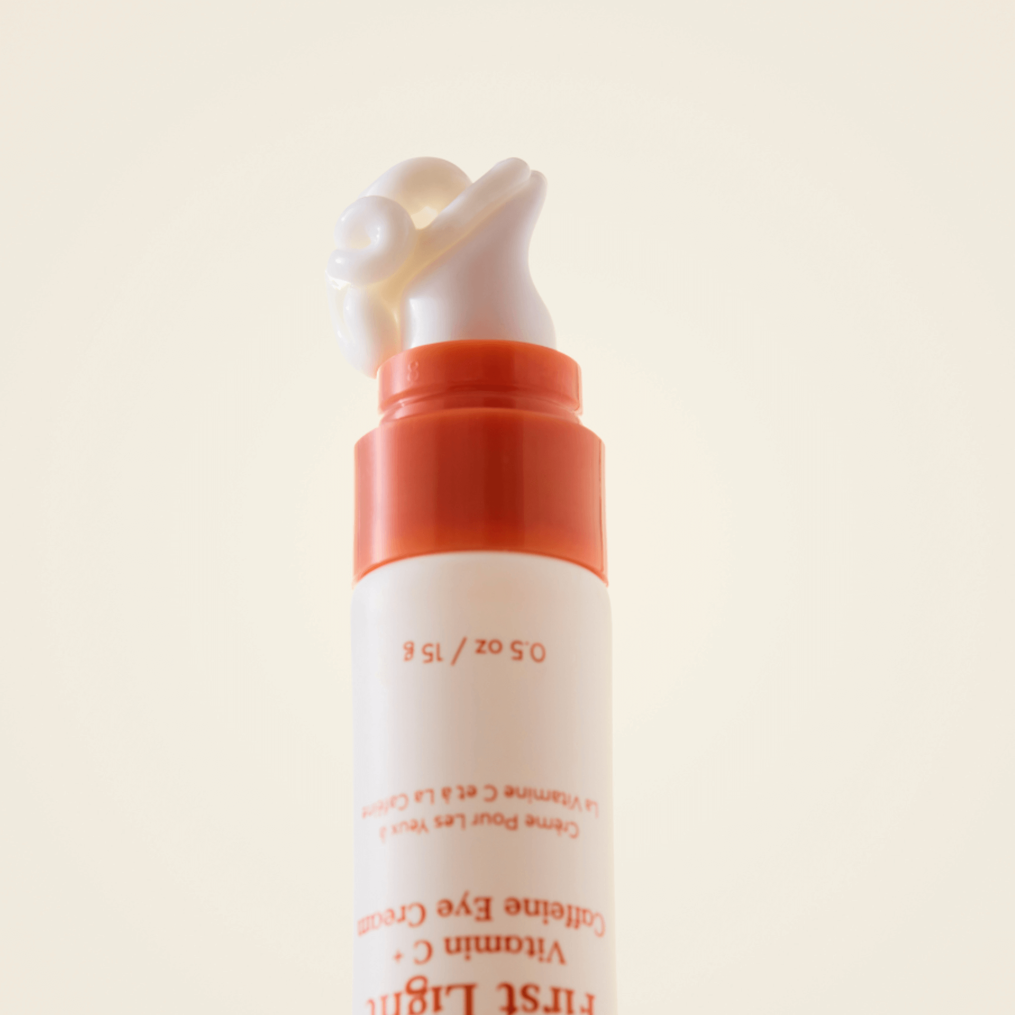 First Light Vitamin C + Caffeine Eye Cream with a pump top, designed for brightening and de-puffing under eyes.