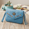 OldTribes Blue handbag with beaded details on a wooden surface with a cactus plant in the background