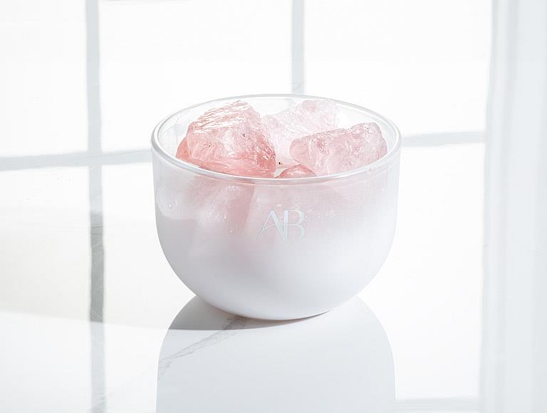 AB rose quartz crystal room fragrance bowl and oil in a white room