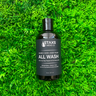 Bottle of Staxs Mens Co all wash on a grass background