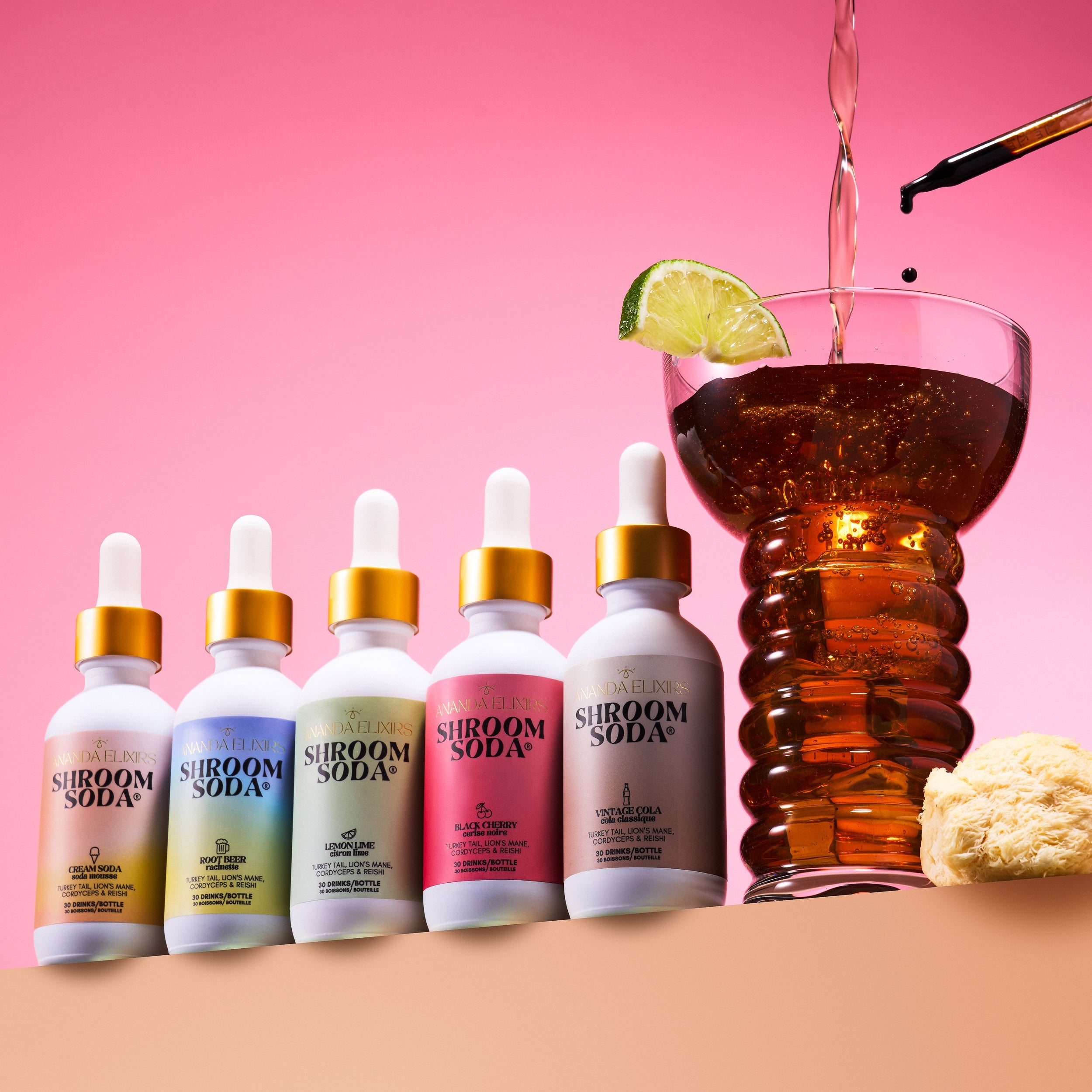 Shroom Soda dropper bottles with a mocktail being poured into a glass on a pink background