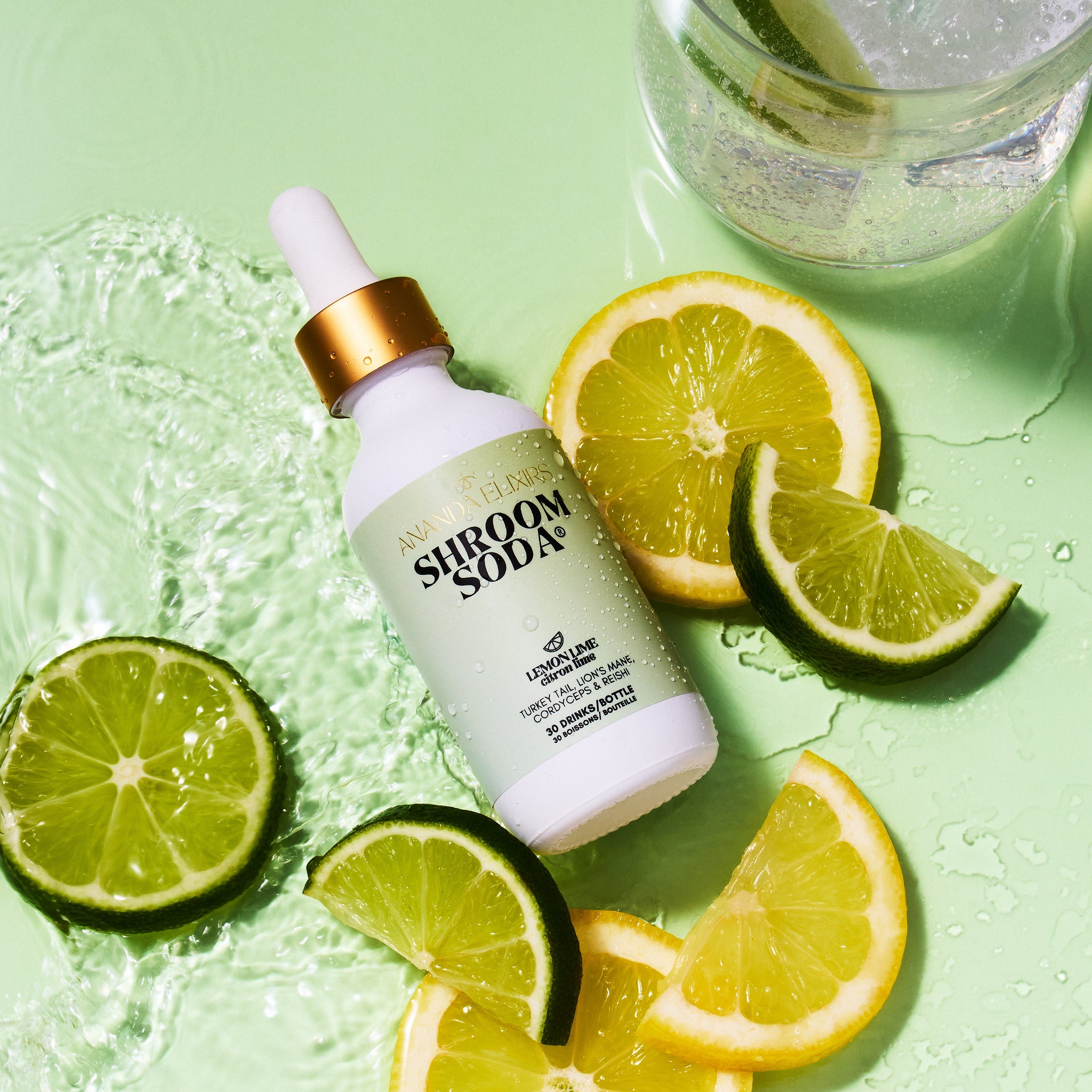 Shroom Soda bottle with lemons and limes on a green background